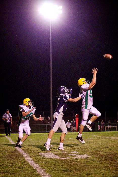 <p>Lakeland High's Taylor Campbell goes up to make an interception while his teammate Casey Thorne closes in behind Kaleb Mitchell from Lake City during the second half.</p>