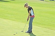 Sophomore Kristin Likens watches her putt during the Ronan Golf Invitational. The Ronan girls would finish fourth in the tournament.