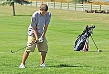 Polson junior Cody Fischer tries to chip onto the green during the Ronan Invitational last Friday at the Mission Mountain Golf Course in Ronan.