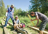 Scout working on River's Edge Park boardwalk