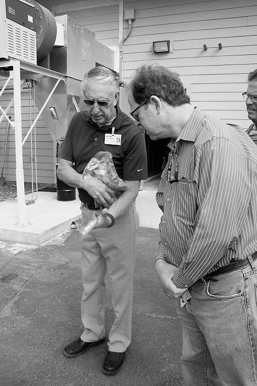 &lt;p&gt;Plant Services Manager Dennis Bursell and Steve Marshall from the United States Forest Service look at the quality of material used in the biomass system.&lt;/p&gt;