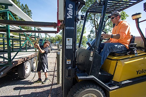 &lt;p&gt;Chris Martin, right, and his cousin's son, Dylan Ralston, 12, take bleachers from a flatbed trailer to put along the trail on Coeur d'Alene Lake Drive in preparation for this weekend's Diamond Cup hydroplane races.&lt;/p&gt;