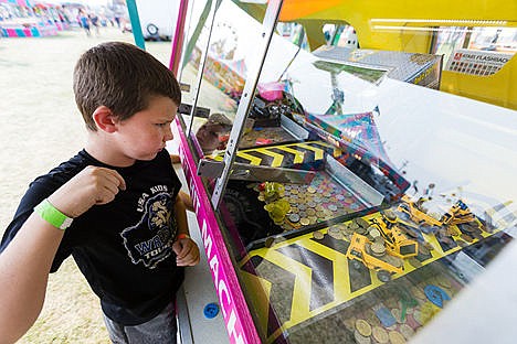 &lt;p&gt;&#160;Ayden Washburn, 8, of Coeur d&#146;Alene, uses his body to urge a coin to drop in a winning position while playing Dozers.&lt;/p&gt;