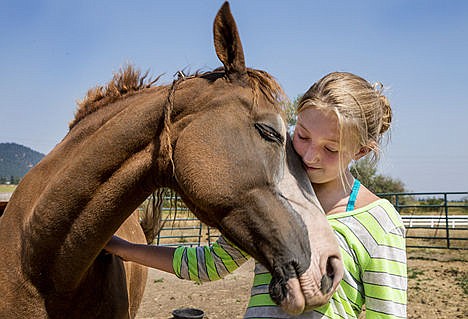 &lt;p&gt;Sarah Thaut, 11, and her 12-year-old chestnut curly horse &#147;Twiz&#148; share a moment August 13 in the Thaut family corral in St. Maries.&lt;/p&gt;