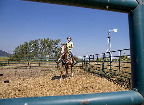 &lt;p&gt;Sarah Thaut warms-up her chestnut curly horse &#147;Twiz&#148; in the Thaut family corral in St. Maries&lt;/p&gt;