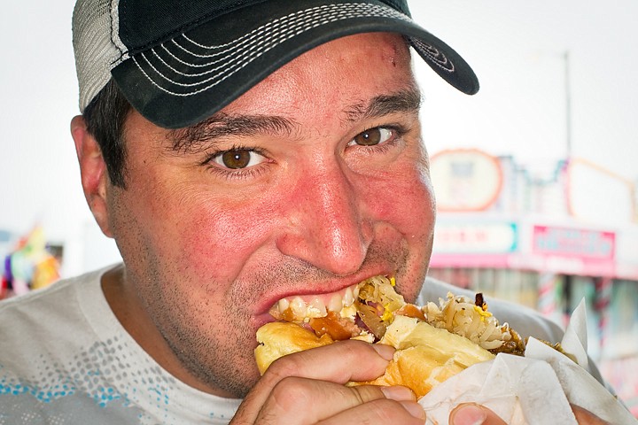 &lt;p&gt;SHAWN GUST/Press Monte Meredith takes a bite out of a sauerkraut covered sausage.&lt;/p&gt;