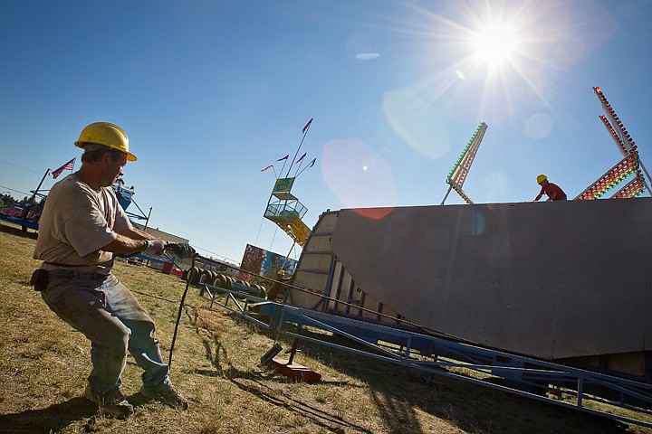 &lt;p&gt;SHAWN GUST/Press Joe Chester tugs on a rope to help steady a platform Tuesday while setting up the Super Sizzler ride at the Kootenai County Fairgrounds.&lt;/p&gt;