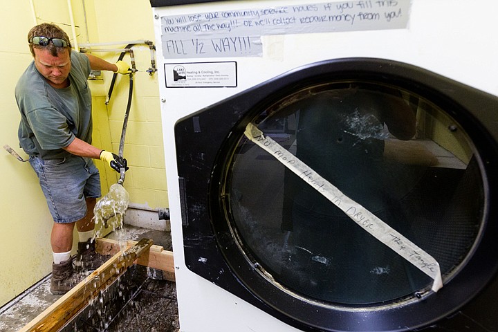 &lt;p&gt;SHAWN GUST/Press Russ Nalley, a worker with Edward Smith Construction, sprays water over an area in preparation for concrete Monday at the Kootenai Humane Society. A new slab was needed where the washer belongs because of deteriorating floor conditions.&lt;/p&gt;