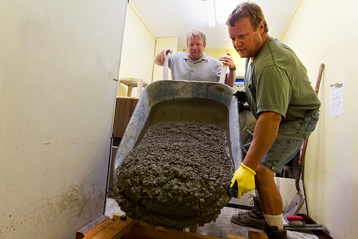 &lt;p&gt;SHAWN GUST/Press Pete Chichester, marketing director for the Kootenai Humane Society, dumps concrete into a form as Russ Nalley steadies the wheelbarrow.&lt;/p&gt;