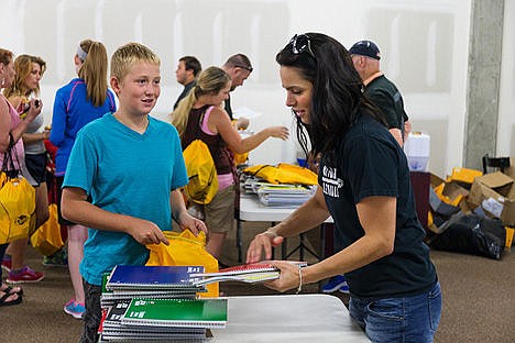 &lt;p&gt;Hyrum Eacho, 14, an incoming freshmen at Lake City High School, receives notebooks from Kelsey Stanley, NIC head volleyball coach, during the free event.&lt;/p&gt;
