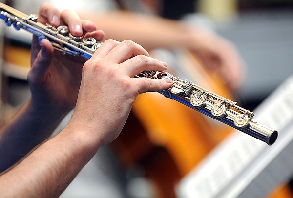 Shawn Wyckoff plays the flute as he and fellow Juilliard students play Devil's Dream/Chicken Reel for gathered students on Thursday at the Discovery Center in Columbia Falls.