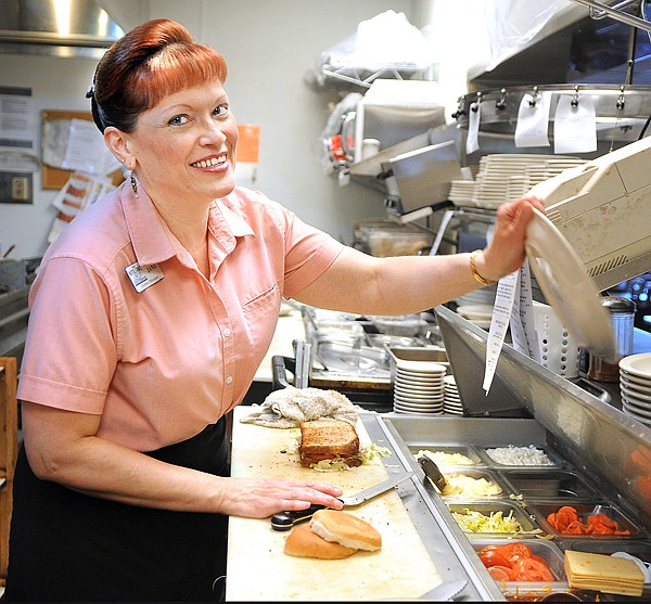 Jana Price, owner/manager of the Nite Owl in Columbia Falls works behind the scenes on Tuesday.