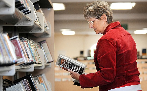 Judy DeCock of Kalispell peruses the audio book selection at the Kalispell Public Library on Friday. DeCock is preparing for a trip to New Mexico, she said an audio book helps the miles fly by.