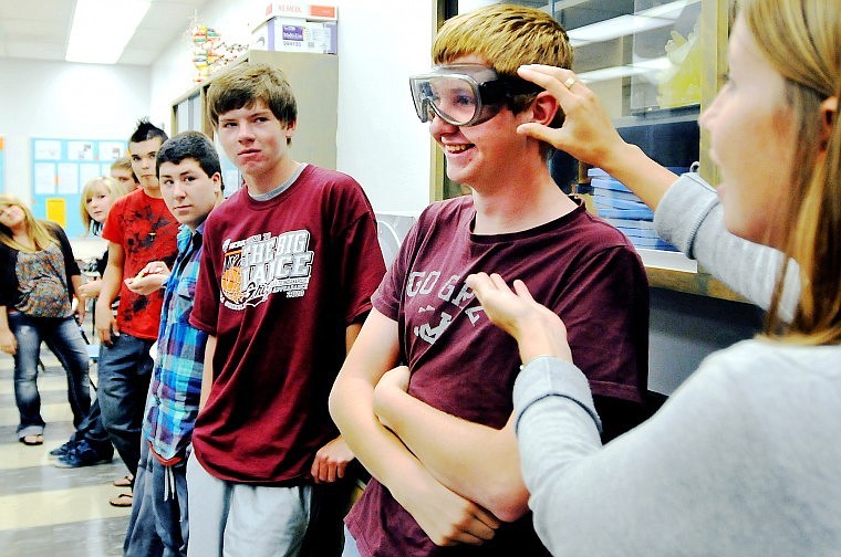 Flathead High School sophomore Eric Hogan models a pair of protective goggles for biology teacher Megan Couser during the first day of class Thursday afternoon. Kalispell high schools plan to revamp the science curriculum.