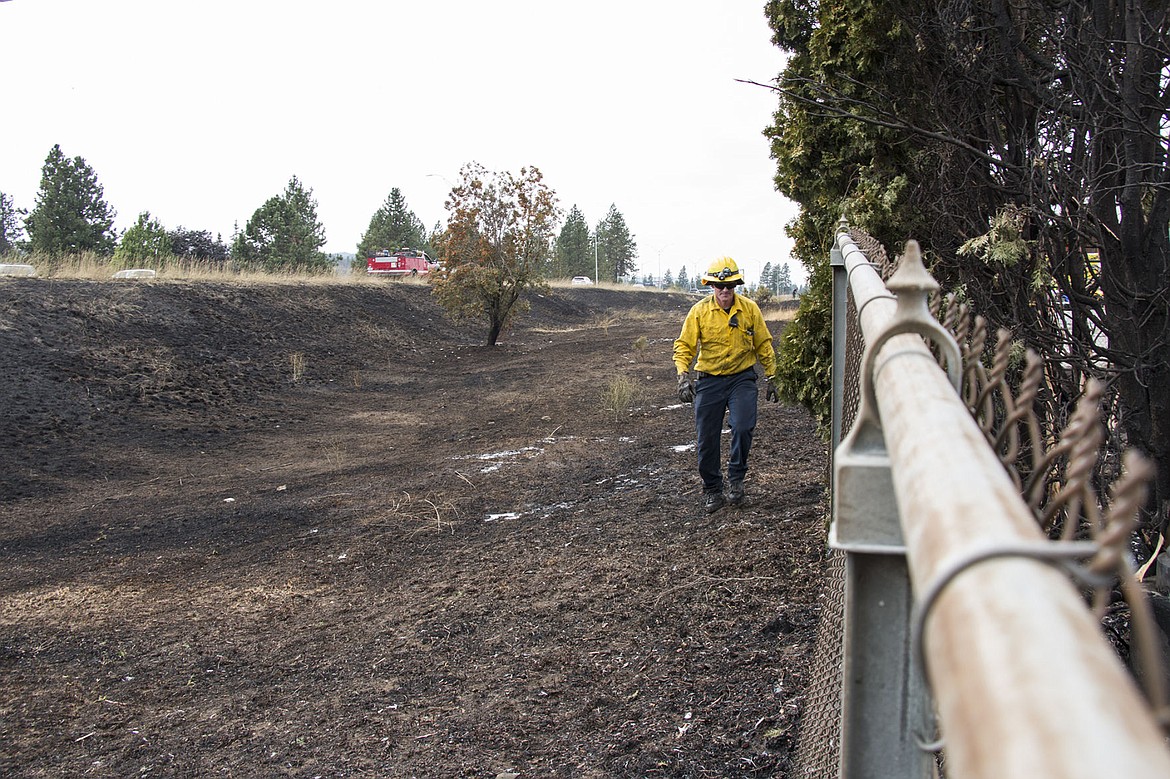 &lt;p&gt;BETHANY BLITZ/Press&lt;/p&gt;&lt;p&gt;A firefighter walks back to the fire trucks after making sure a fire is completely out. The fire on Interstate 90 east U.S 95 burned 1.57 acres of grass and damaged four parked vehicles and some property of a nearby business. No one was hurt.&lt;/p&gt;