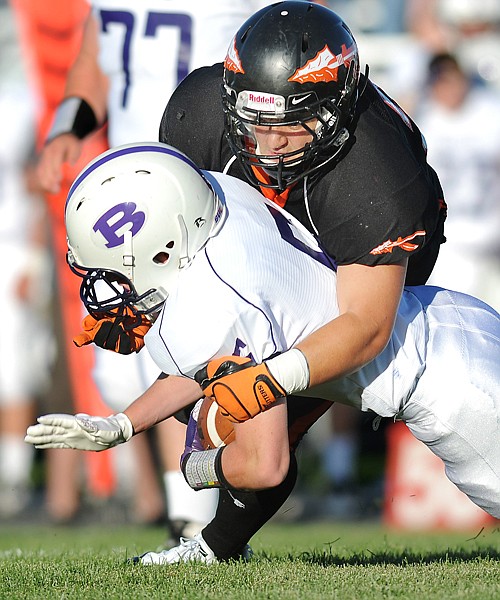 Flathead linebacker Travis Ozegovich, 33, takes down Butte running back Kyle Shaw, 5, during the first half of their game on Friday in Kalispell. At half time Butte was up 24 to 7.