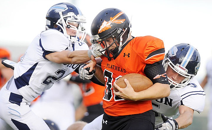 &lt;p&gt;Flathead Braves running back Payton Boyce is pulled down by the face mask after a long run on the Braves' opening drive at Legends Stadium Friday night. (Aaric Bryan/Daily Inter Lake)&lt;/p&gt;