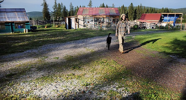 Joseph Fetherolf, 21, originally from Waitsfield, Vt., makes his way in from doing morning chores on Friday, July 30.