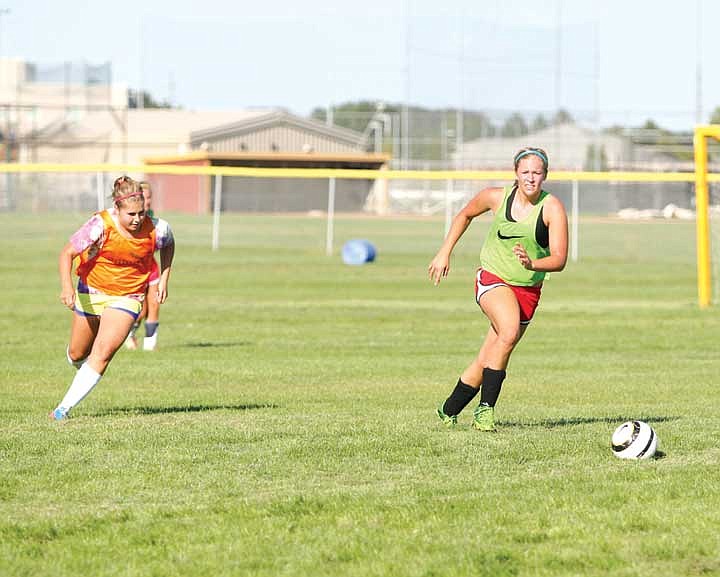 Team captain McKenna Walker dribbles the ball during a scrimmage at the end of the Moses Lake Chiefs girls soccer practice Tuesday.