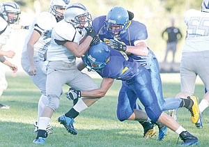 &lt;p&gt;Taraski Krisanov and Dalton Brown go high and low to tackle Badger Bryan Yeomans in first quarter action Saturday night.&lt;/p&gt;
