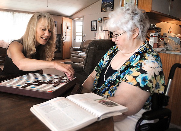 &lt;p&gt;Kathy Warmoth of Agape Home Care plays Scrabble with Linda
Powell on Friday morning in Evergreen.&lt;/p&gt;