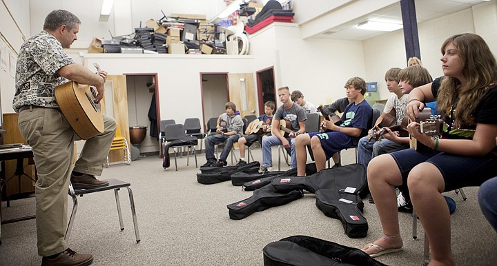 &lt;p&gt;Kurt Weber, left, demonstrates how to strum to his introductory
guitar class during the first day of school at Evergreen Junior
High on Wednesday morning.&lt;/p&gt;