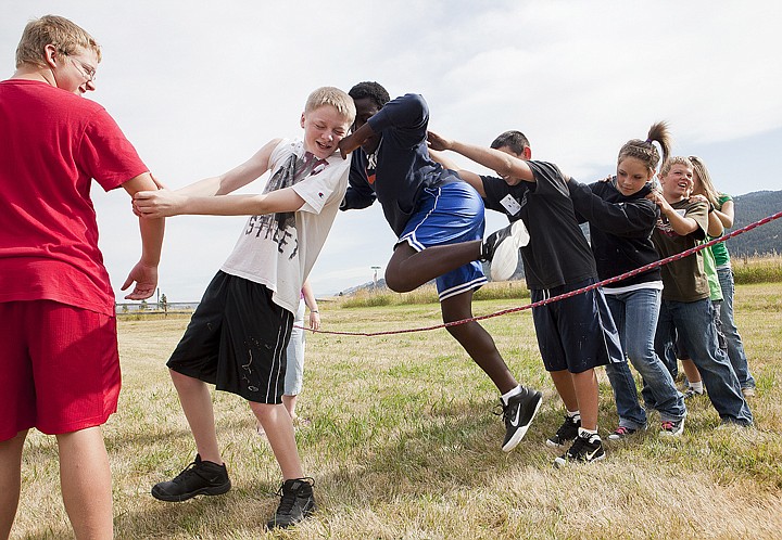 &lt;p&gt;Nathan Sommers, center, uses the shoulder of Gauge Anderson to
hop over a rope without touching it during team building exercises
at Kila School on Thursday morning. The students had to get over
the rope without losing contact with their team members.&lt;/p&gt;