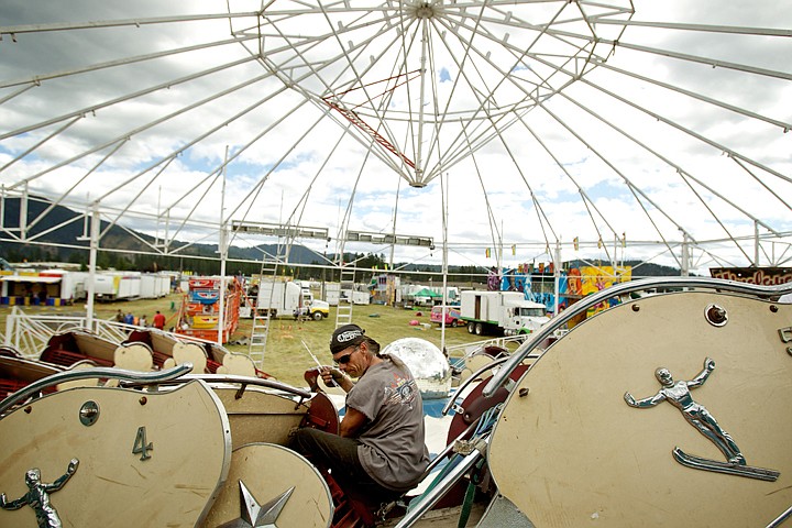 &lt;p&gt;JEROME A. POLLOS/Press Michael Smith works on constructing the Himalaya ride on the midway Monday as the other rides and attractions are moved into position for the start of the fair.&lt;/p&gt;