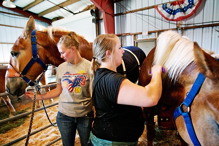 &lt;p&gt;JEROME A. POLLOS/Press Cailin Brunner, right, and Dani Wessling prepare two Belgian draft horses for display Thursday at the North Idaho Fair.&lt;/p&gt;