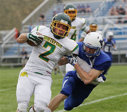 &lt;p&gt;Whitefish's Chris Park pushes off a Havre defender for a first down during a high school football game Saturday, Aug. 29, 2015, in Havre, Mont. (Roger Miller/Havre Daily News via AP)&lt;/p&gt;