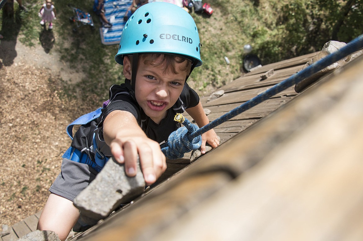 &lt;p&gt;BETHANY BLITZ/Press Ethan Rumpler, 8, scales the rock wall at Lutherhaven, during the camp&#146;s 70th anniversary celebration. A camp kid himself, Rumpler said he likes playing at the beach the most.&lt;/p&gt;