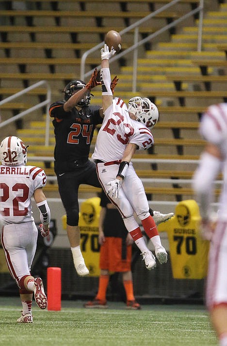 <p>Colton Engel (23) of Sandpoint and Zach Hillman (24) of Post Falls vie for a pass Saturday night at the Kibbie Dome.</p>