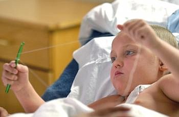 KILEY HEFFNER pulls her thread taut around a crochet hook while waiting for blood test results and lunch at Kalispell Regional Medical Center's outpatient infusion center Wednesday morning. Allison Money/Daily Inter Lake