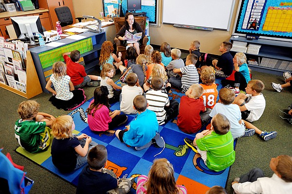 &lt;p&gt;Stephanie Kolar reads to the second graders at Peterson Elementary on Wednesday, August 29, in Kalispell. Her co-teacher, Lauren Beach, used the time to place activity sheets on the student's desks.&lt;/p&gt;