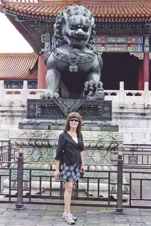 Chief Moses Middle School teacher Samantha Myers stands next to
a female lion statue in China's Forbidden City during a trip to
China sponsored by the National Consortium for Teaching About
Asia.