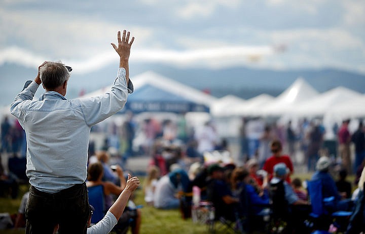 &lt;p&gt;A crowd member waves as planes make a pass on Saturday, August 30 at the Mountain Madness Air Show. (Brenda Ahearn/Daily Inter Lake)&lt;/p&gt;