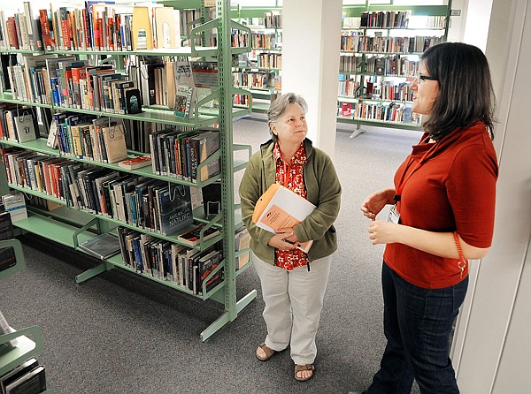 Rishara Finsel of Kalispell, right, a public services librarian helps train Mary Quimby of Columbia Falls on Friday in Kalispell. Quimby will be working at the Columbia Falls Library Branch when she completes her training. All staff are trained at the main library in various aspects of library service.