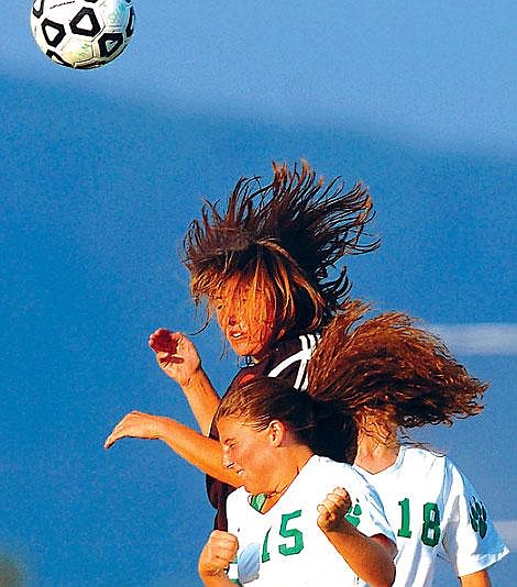 Flathead&#146;s Meghan O&#146;Connell gets up for a header over Whitefish&#146;s Amy Wright, left, and Sarah Clark, right, during Flathead&#146;s 3-0 win Tuesday in Whitefish. Chris Jordan/Daily Inter Lake