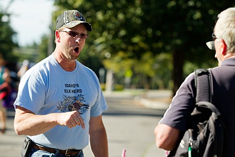 &lt;p&gt;Wayne Hammond, of Rathdrum, emphatically argues his view in favor wolf management to wolf supporter Marty Stitsel, of Sandpoint, in a parking area nearby the wolf rally.&lt;/p&gt;