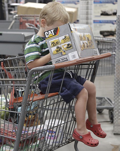 &lt;p&gt;In this Aug. 26, 2011 photo, a young shopper peers into a box containing a CAT motorized job site machine, as he waits to get through the check-out at Costco in Mountain View, Calif. A private research group said Tuesday, Aug. 30, 1011, that consumers? confidence in the economy in August dropped almost 15 points to the lowest level since April 2009 as worries about the economy fueled the wildest stock market swings since the financial meltdown in 2008. (AP Photo/Paul Sakuma)&lt;/p&gt;