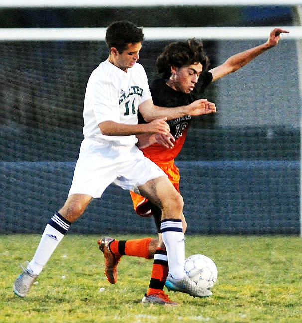 <p>Glacier's Micah Reason and Flathead's Jace Darrow fight for the ball during the first half on Saturday, Oct. 3, 2015 in this file photo. (Aaric Bryan/Daily Inter Lake)</p>