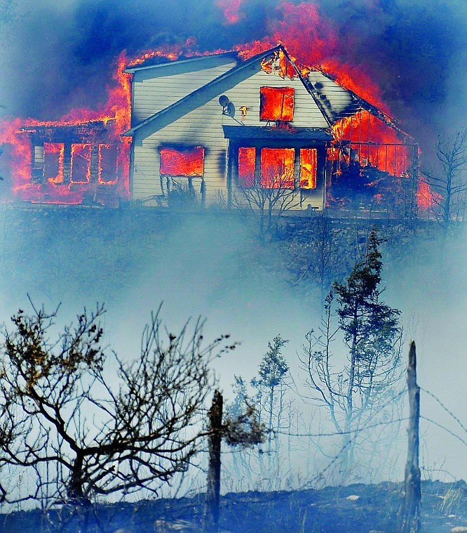 <p> A home burns just north of East River Road in the Pine Creek Fire in Paradise Valley near Livingston Wednesday.</p>