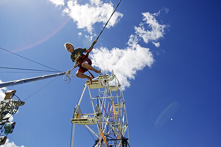 &lt;p&gt;JEROME A. POLLOS/Press Alex Mallet, 10, launches into the air near the ferris wheel Friday as he launches himself on the bungee trampoline.&lt;/p&gt;