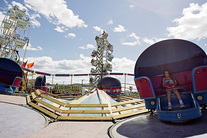 &lt;p&gt;JEROME A. POLLOS/Press Ky Dissinger, 7, takes a spin in one of the midway rides Friday.&lt;/p&gt;