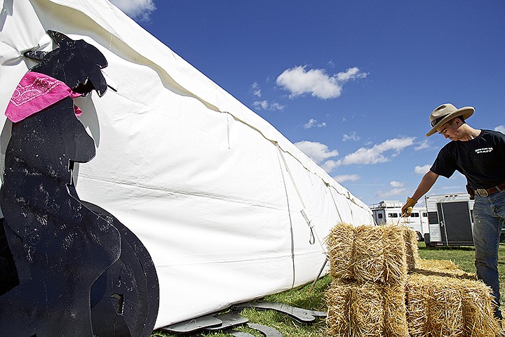 &lt;p&gt;JEROME A. POLLOS/Press Tucker Wilson lifts a bale of hay as they prepare a VIP area for the rodeo.&lt;/p&gt;