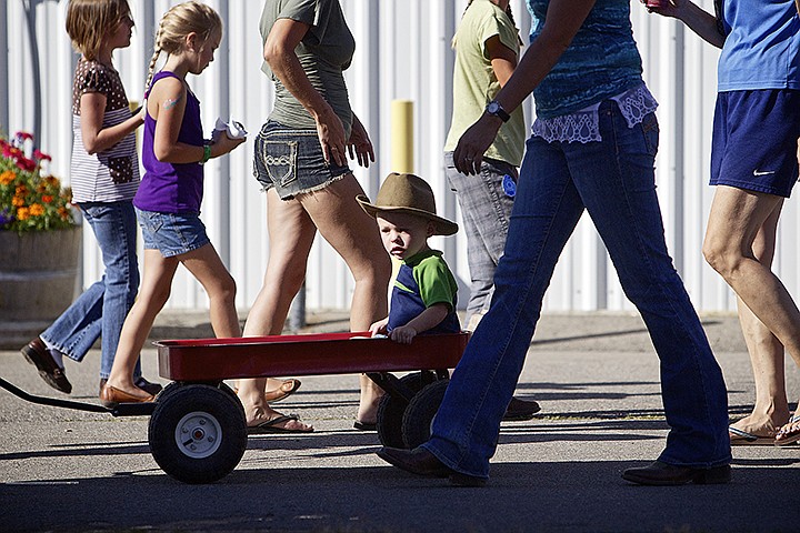 &lt;p&gt;JEROME A. POLLOS/Press Wheeler Holbrook, 1, checks out the sites from his wagon as he is pulled through the fair crowd Thursday near the midway.&lt;/p&gt;