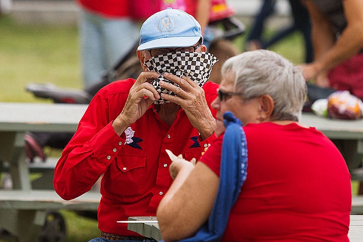 &lt;p&gt;Bob Hart, of Hayden Lake, dives into an Italian sausage, a meal he eats every year at the fair, while waiting to participate in his square dancing performance.&lt;/p&gt;