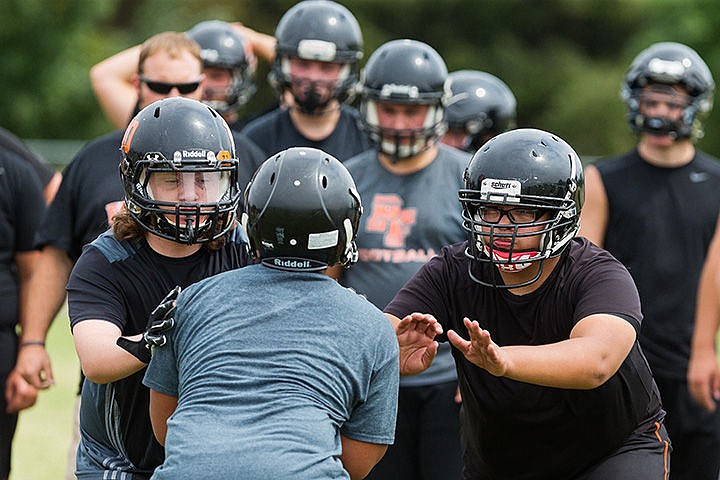 &lt;p&gt;Chris Ransdell, left, and Norberto Chacon, both juniors, block a defender during a lineman drill Monday at Post Falls High School, the first practice of the fall season.&lt;/p&gt;