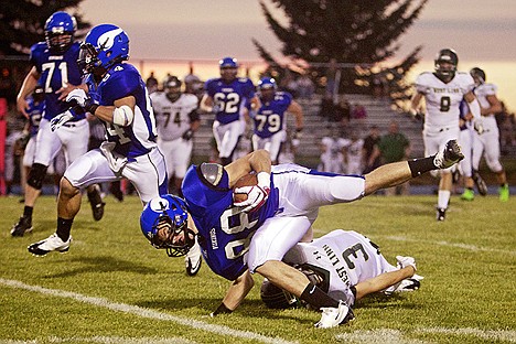 &lt;p&gt;Coeur d'Alene High receiver Camden Doering keeps himself from going down after behind hit by Mario Mastrandrea from West Linn High in the first half of the Viking's 58-20 win over the Lions. Doering would make it to the end zone in the 46-yard play.&lt;/p&gt;