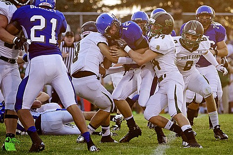 &lt;p&gt;Coeur d'Alene quarterback Gunnar Amos battles his way through the West Linn High defense.&lt;/p&gt;